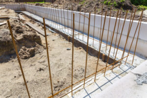 Construction site with metal rods in concrete foundation