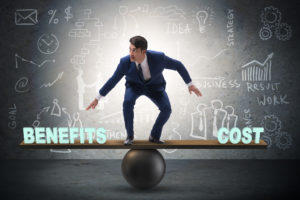 Businessman balancing between cost and benefit in business conce