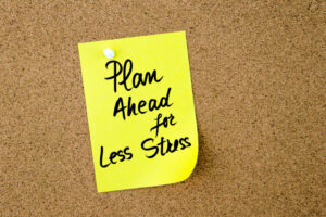 Plan Ahead For Less Stress Written On Yellow Paper Note