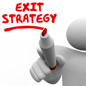 Exit Strategy words written by man with a red pen or marker planning a way out of an agreement, contract, partnership, marriage or other arrangement