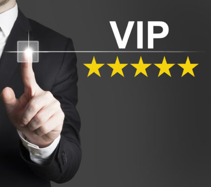 businessman in black suit pushing button vip five stars